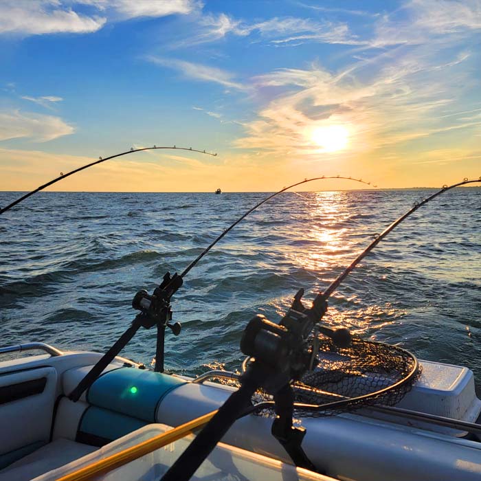 boat out on lake erie with fishing rods hanging off of it