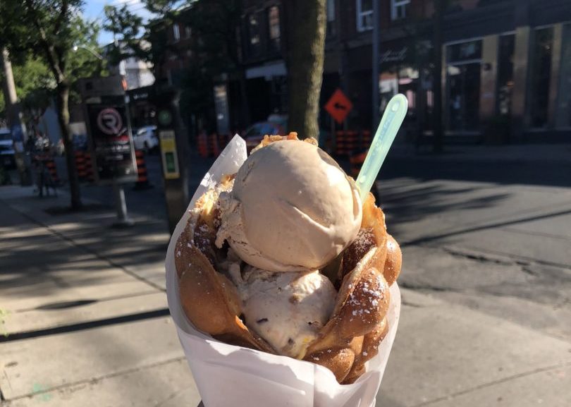 Woman hold a double scoop of ice-cream from Bang Bang Ice Cream and Bakery/