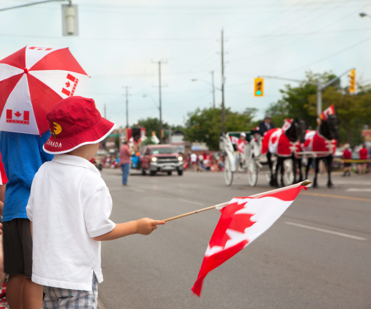 Boy watching a Canada Day parade.