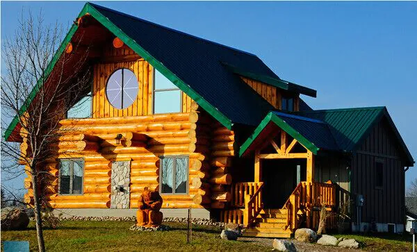 Log cottage with green roof.