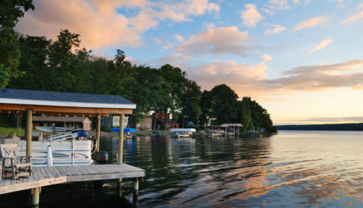 Lake house with pier and woods with sunrise in the morning