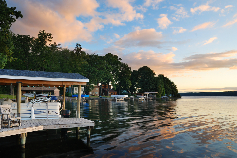 Lake house with pier and woods with sunrise in the morning