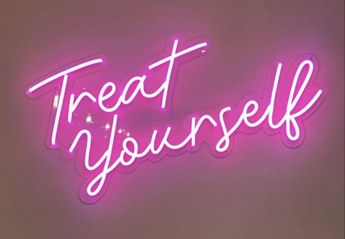 Neon sign of the words: "Treat Yourself".