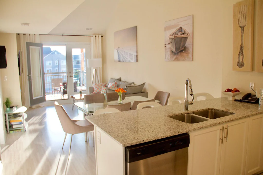 Living room and kitchen with balcony doors.