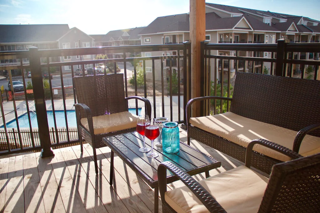 Patio furniture on third-floor balcony, looking over resort pool.