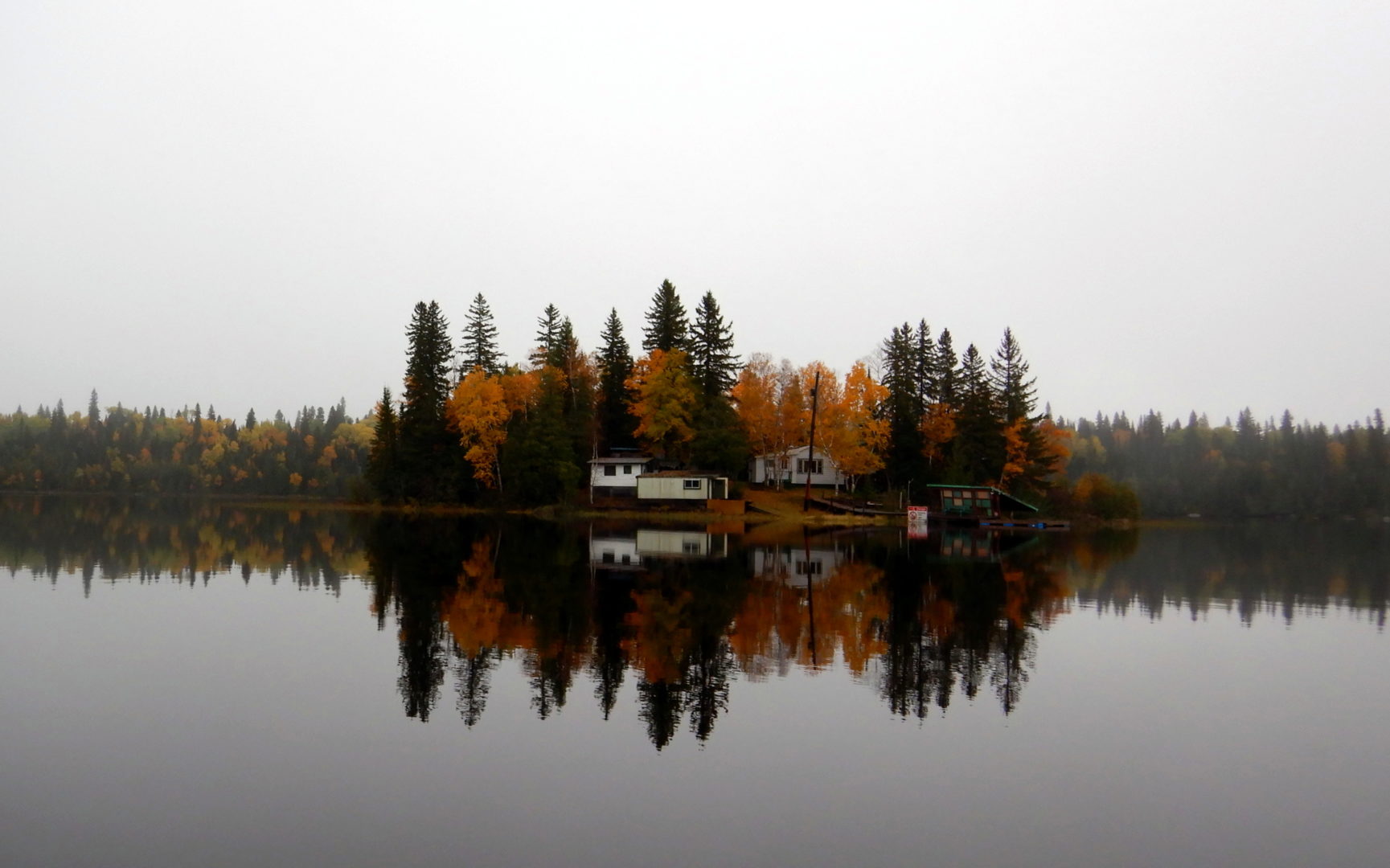 Photo contest entry of cottage tucked away on an island in the fall.