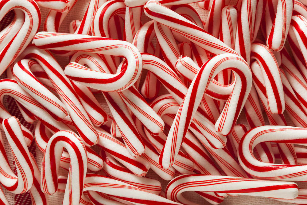 A close-up of a pile of red and white candy canes