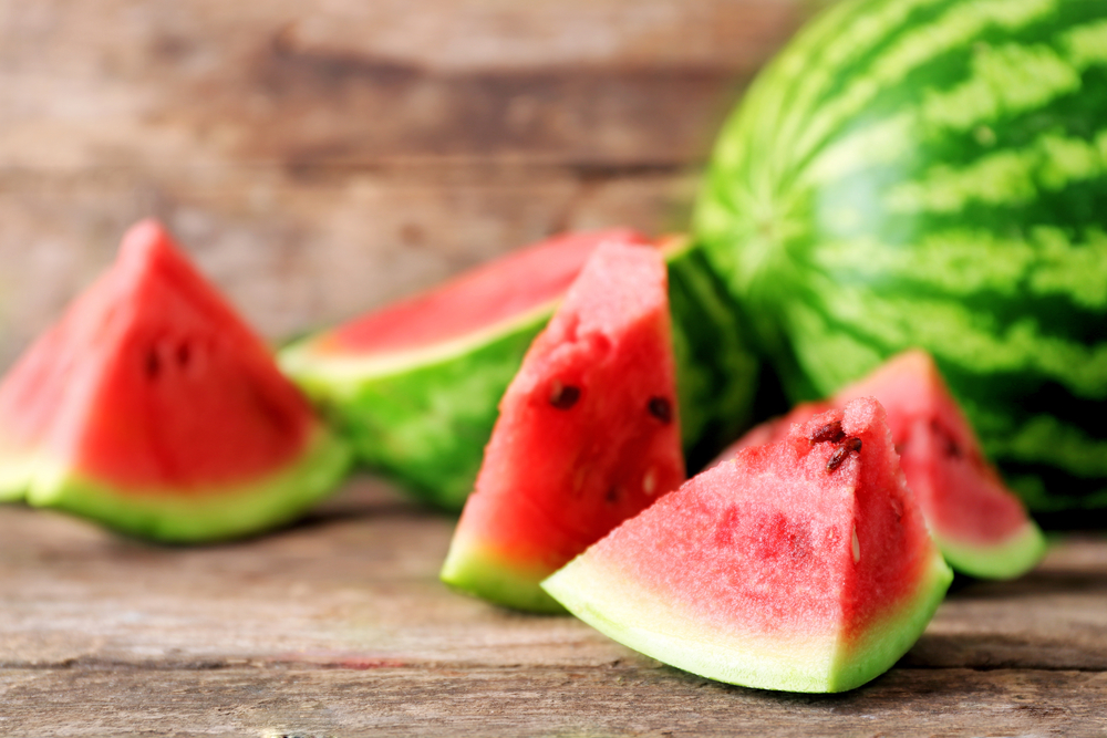 Slices of watermelon against a wood background