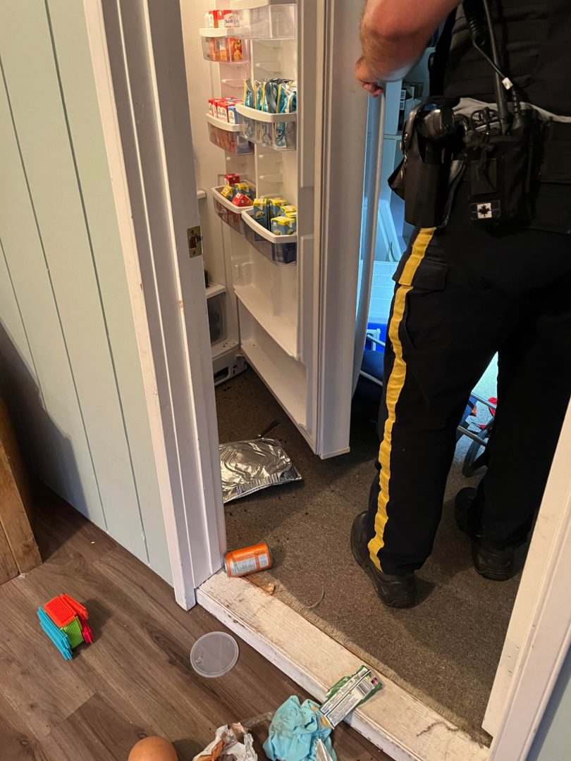 RCMP officer investigates the cottage interior