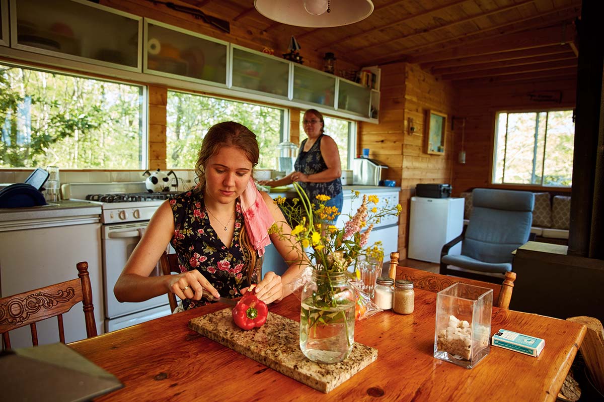 Sam and Tammy prepare food in the kitchen.