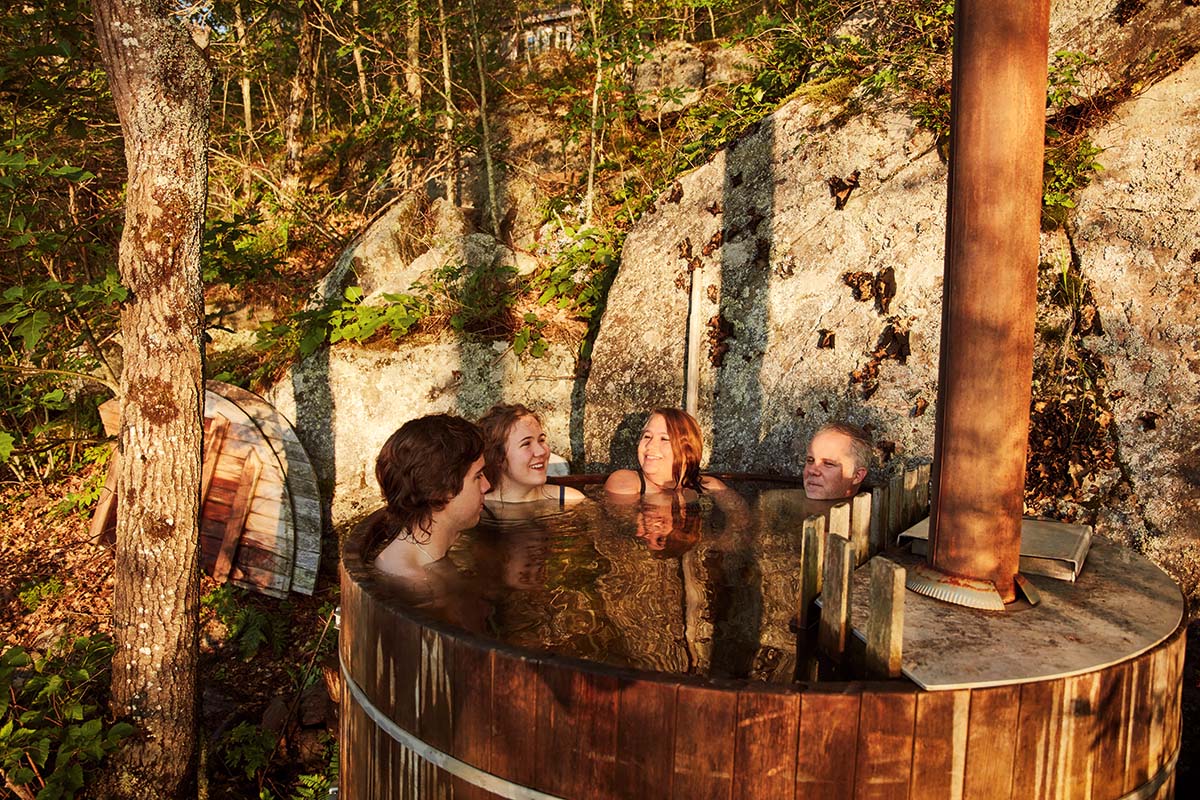 The Macklin family sit in their wood-fired hot tub.