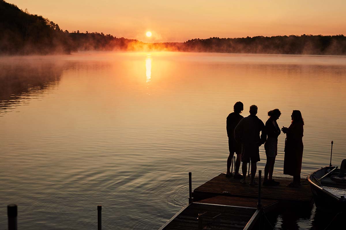 Tha Macklin family watches the sun rise off their dock.