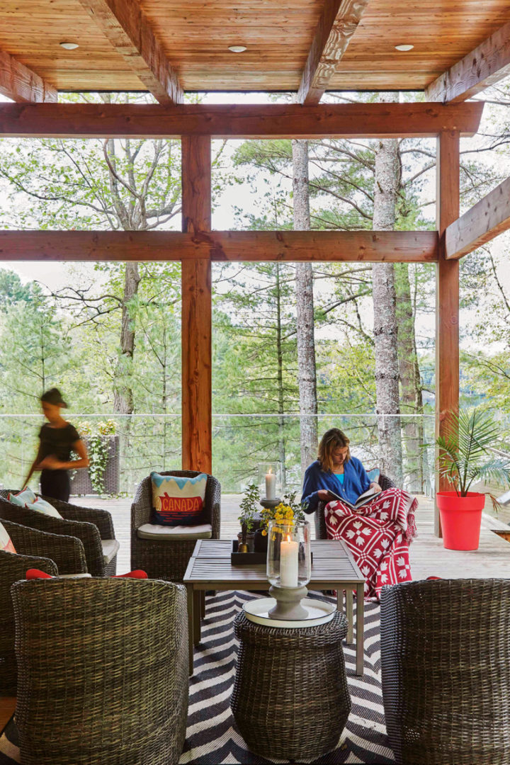 Kid sitting on the covered porch outside the cottage