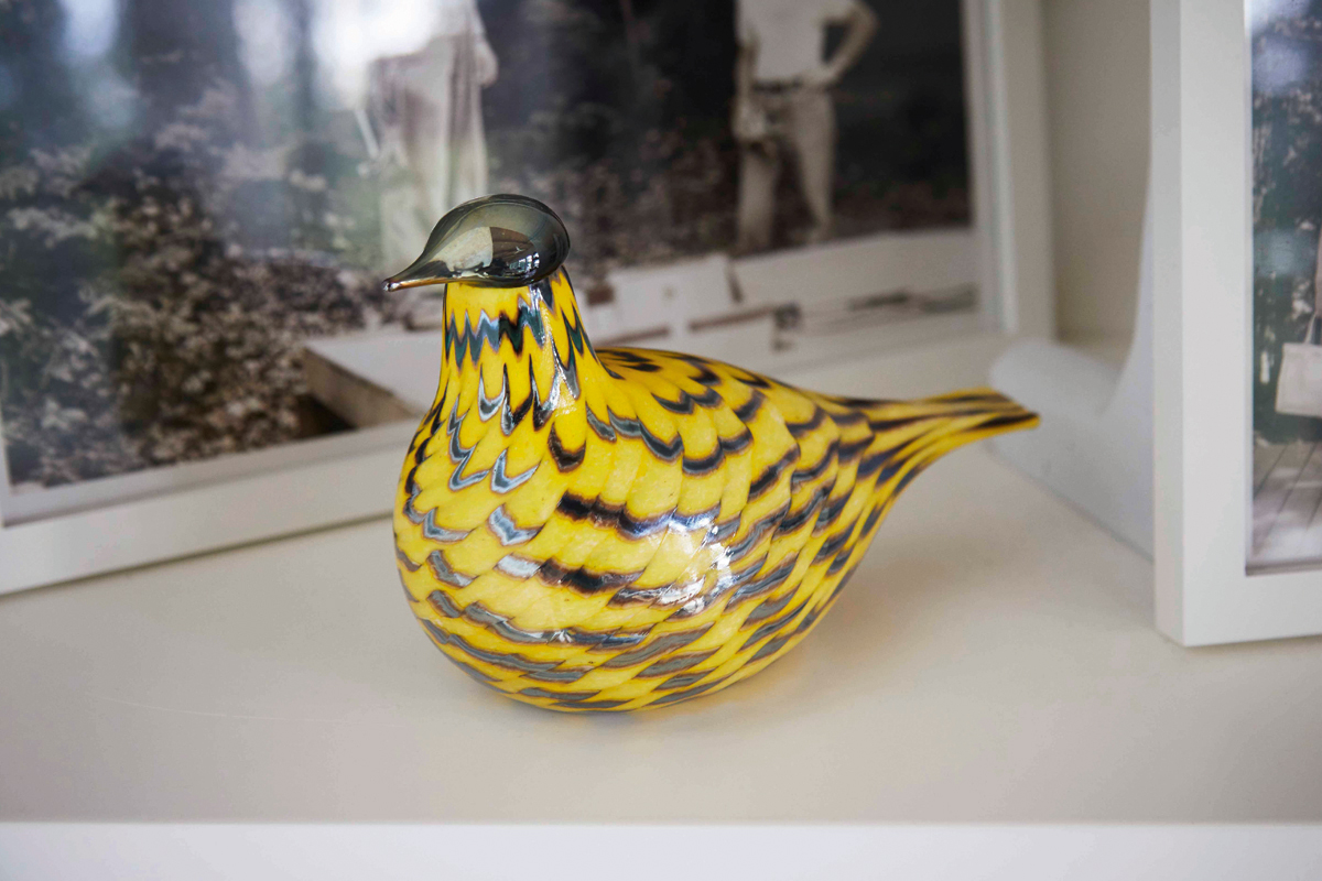 a small yellow glass bird sits on the counter
