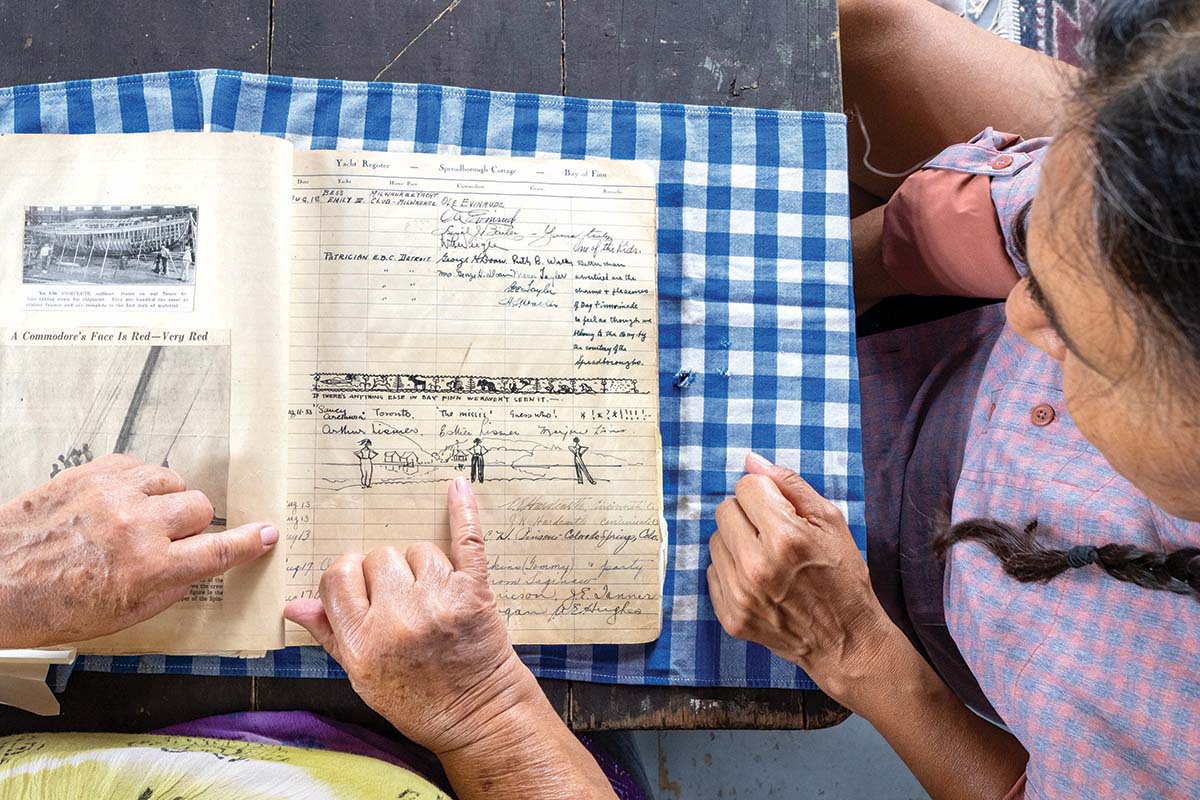 Christina examines and old note book.