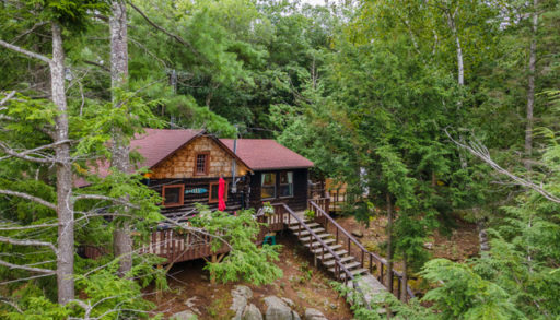 exterior of a cottage with cedar shake in the trees