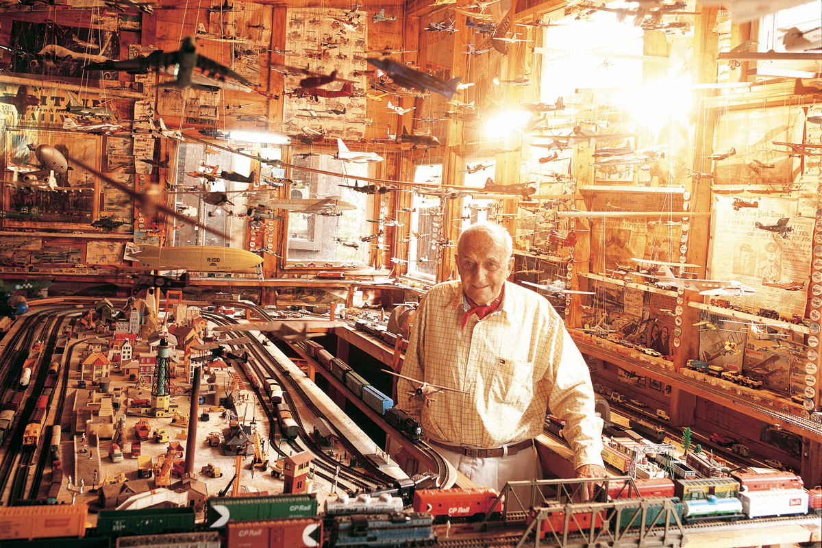 Ralph Silverstone, a cottager, stands in his museum of airplanes and trains