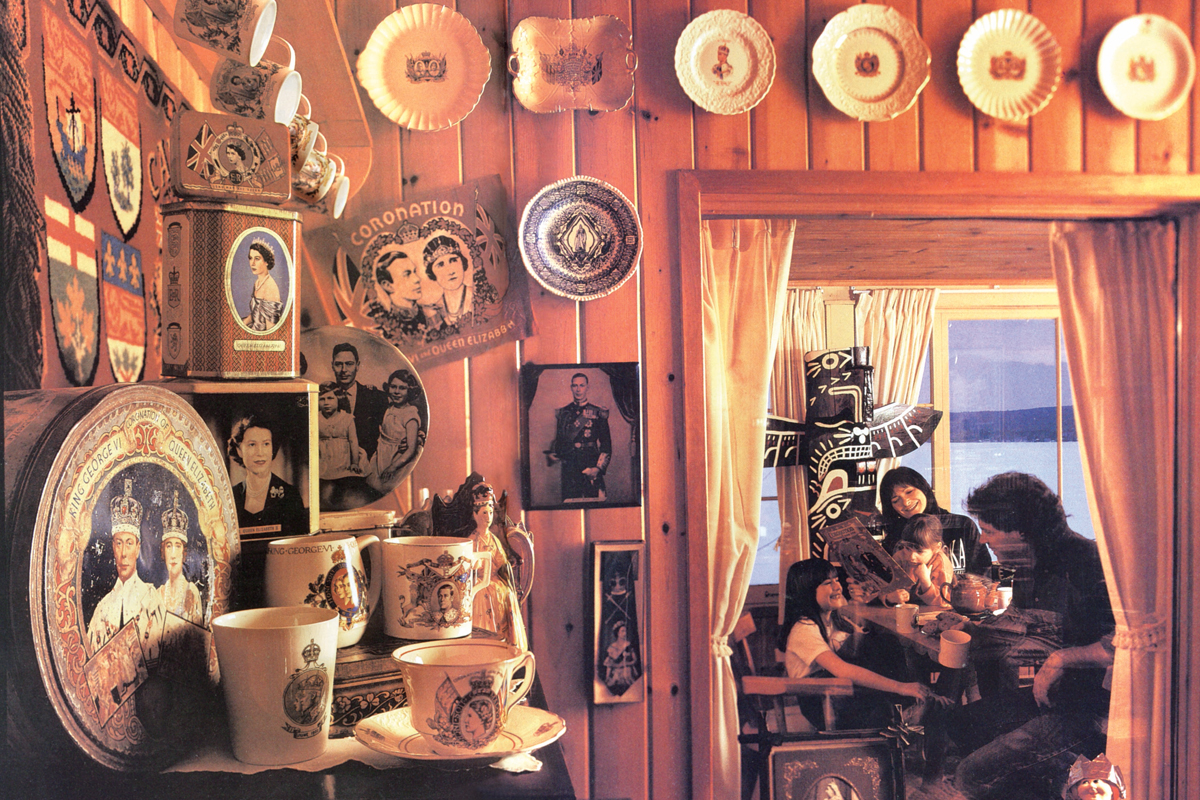 a collection of English-royal themed plates, tea cups, and tins