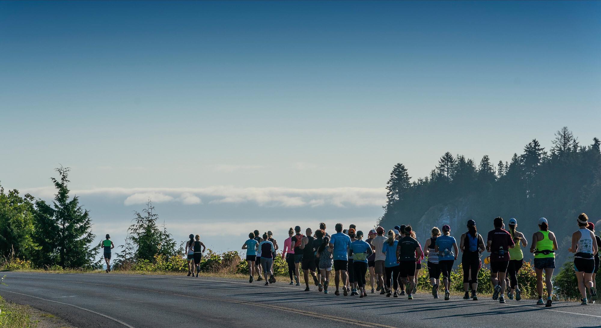 Marathon participants race along the island's coast.