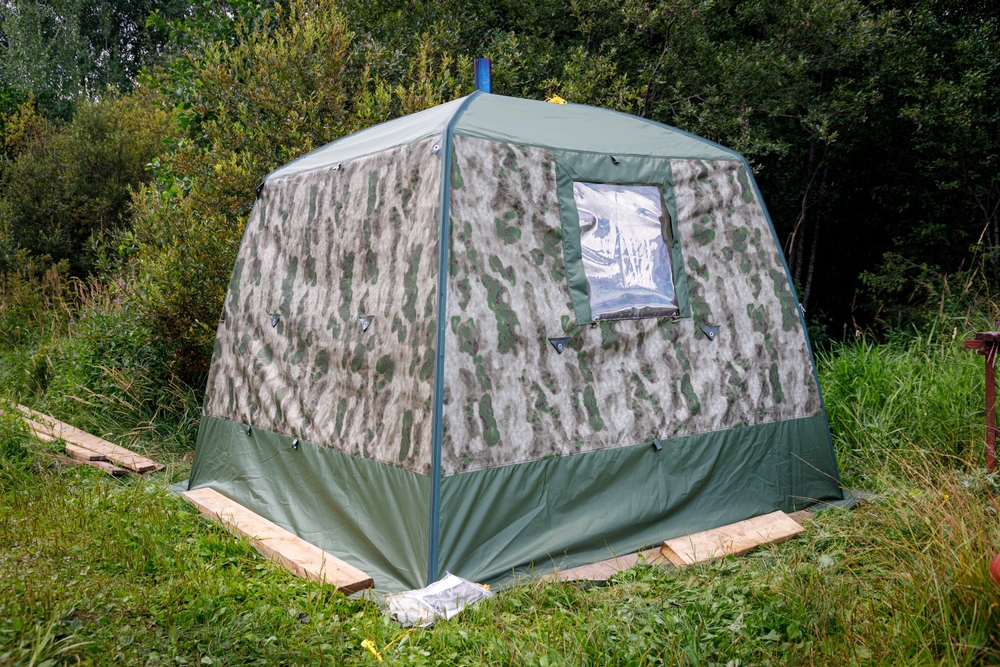 A tent sauna standing in a field