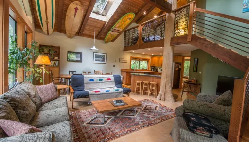 surfboards adorn the ceiling of the main living area