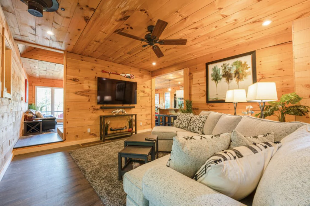 Large couch fills wood panelled room
