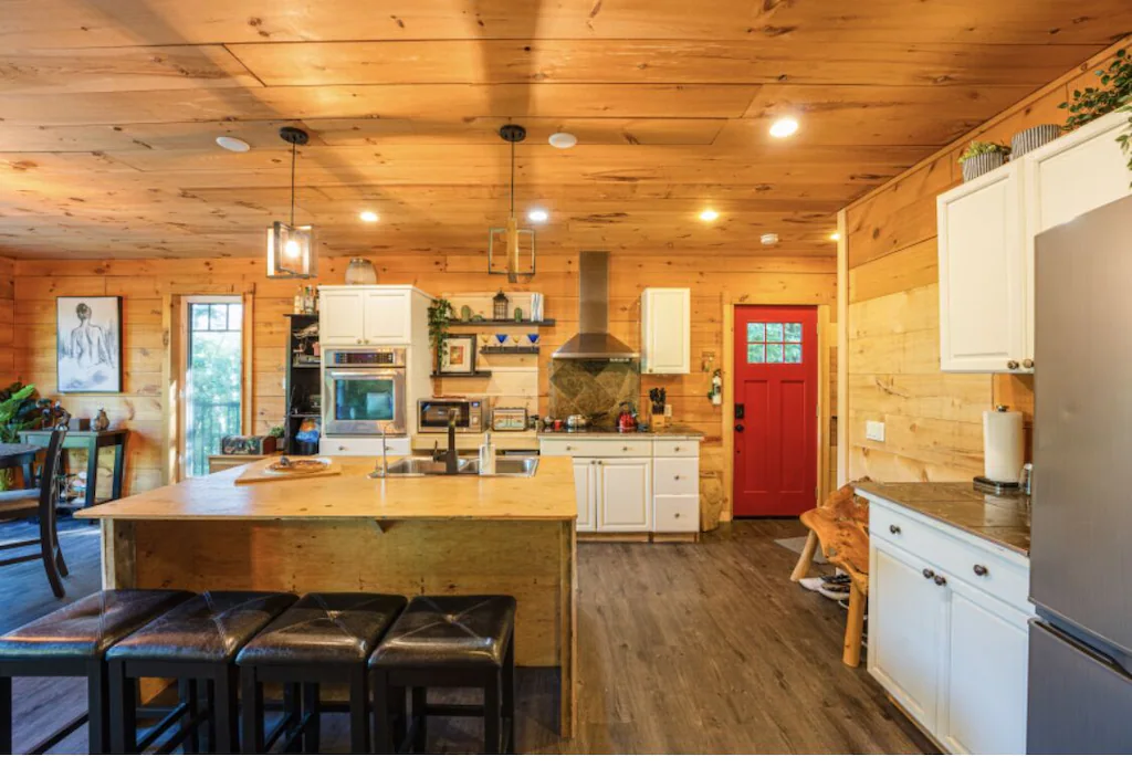Large open-concept kitchen with lights on