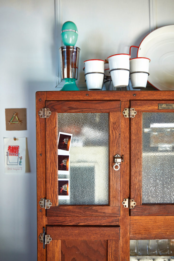 A close-up of the Hoosier cabinet that holds kitchen things