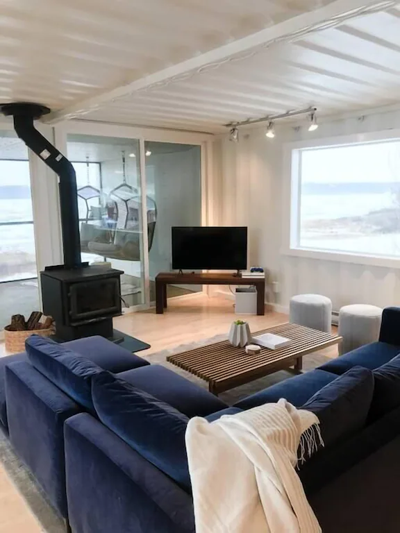 fireplace and television set up in living room of container cabin