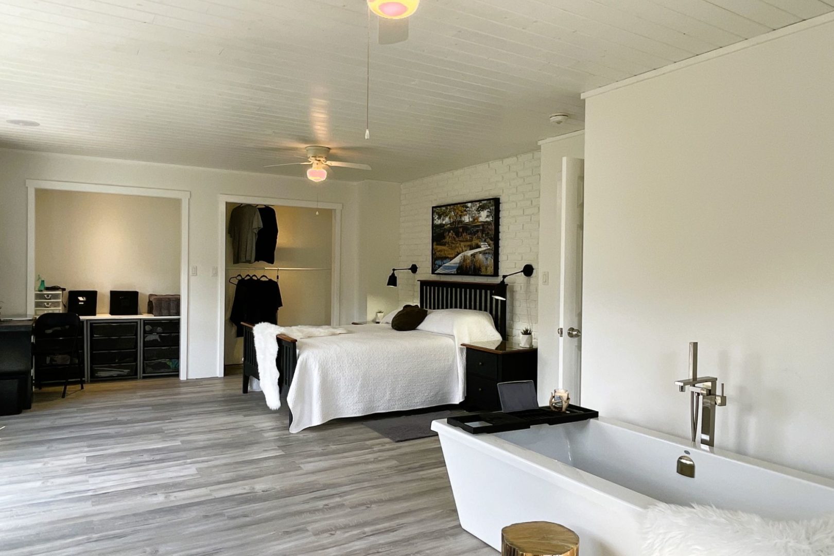spacious bedroom with bath tub in the corner