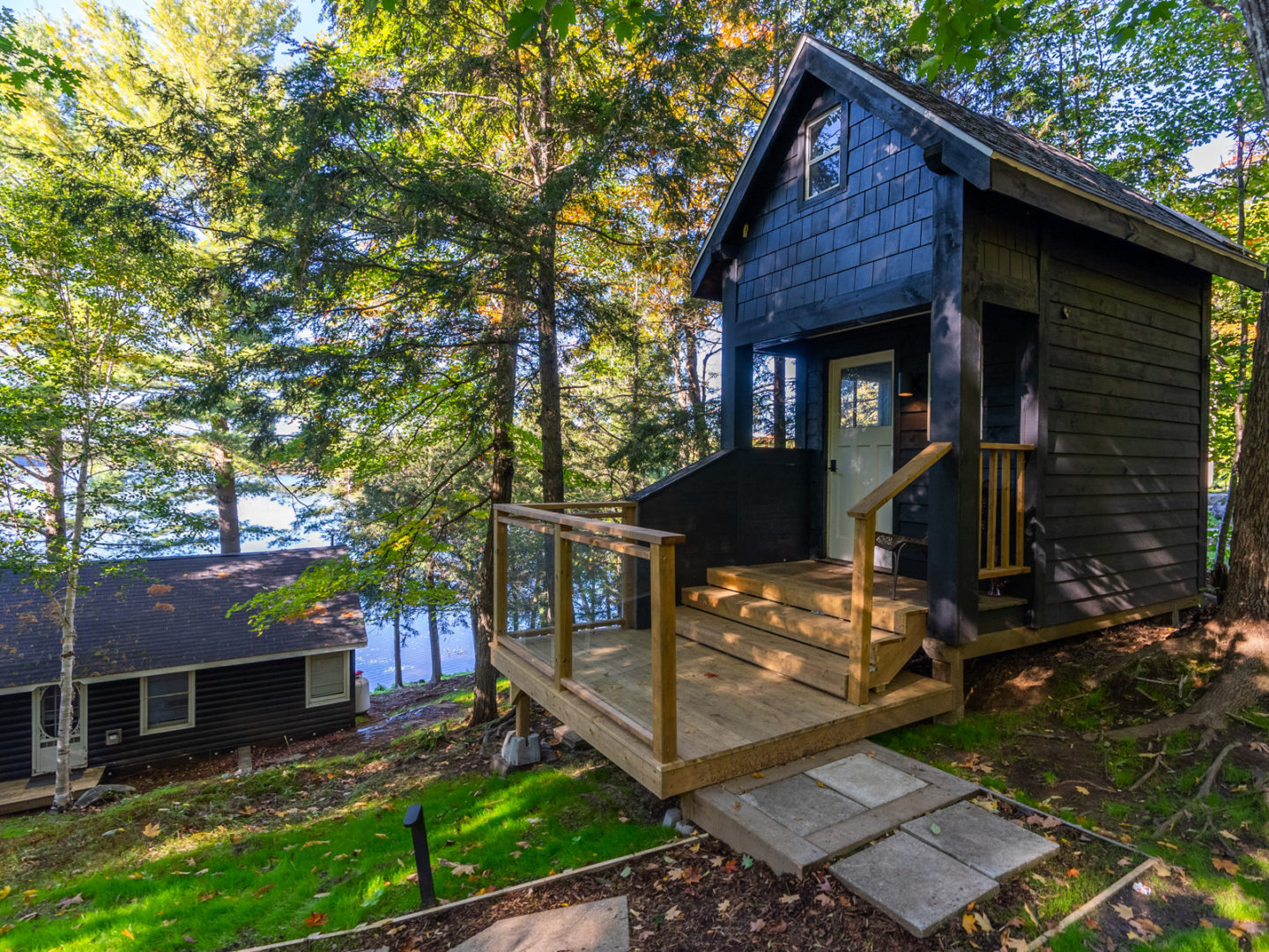 A small bunkie with a little wooden porch.