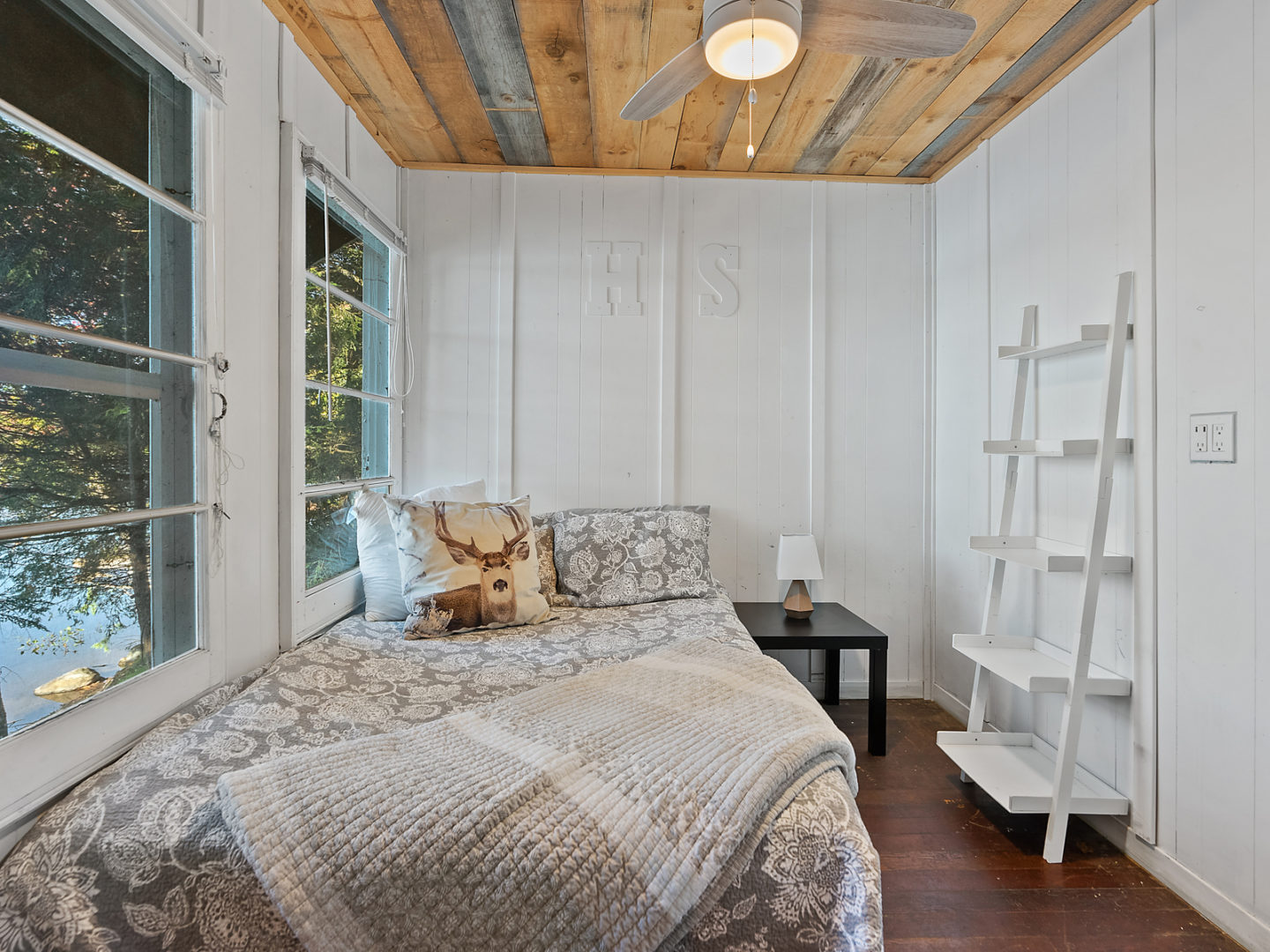 A modest bedroom with a small bed, modern decor.