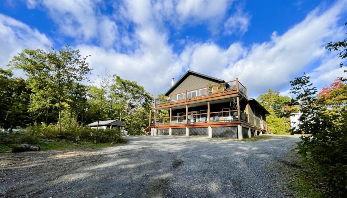 zoomed out shot of the house from the driveway