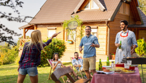 group of friends at a cottage playing badminton