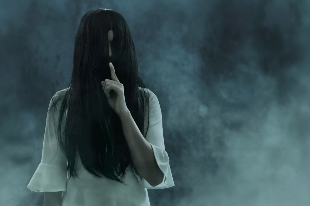 A ghostly woman against a misty dark background