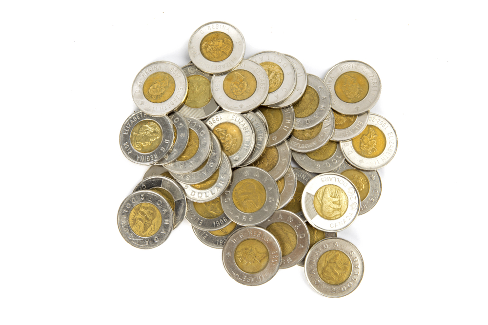 A pile of toonies against a white background
