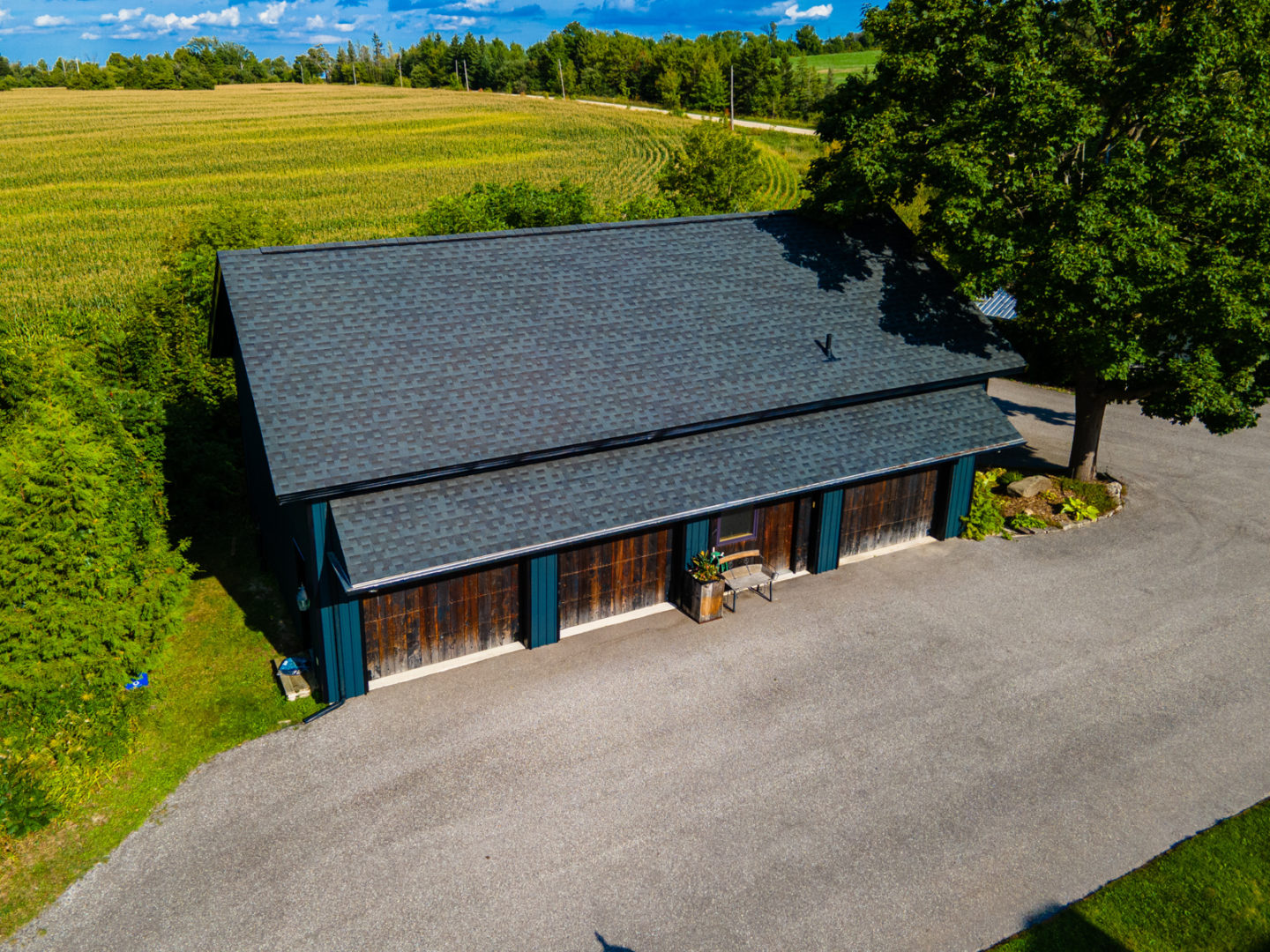 A small building with four garage doors in the front and a sloping roof.