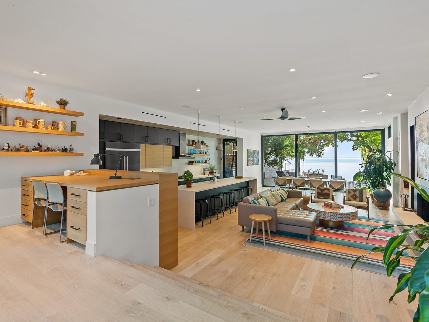 A open-concept living space with a living room, kitchen, and dining area in one large room.