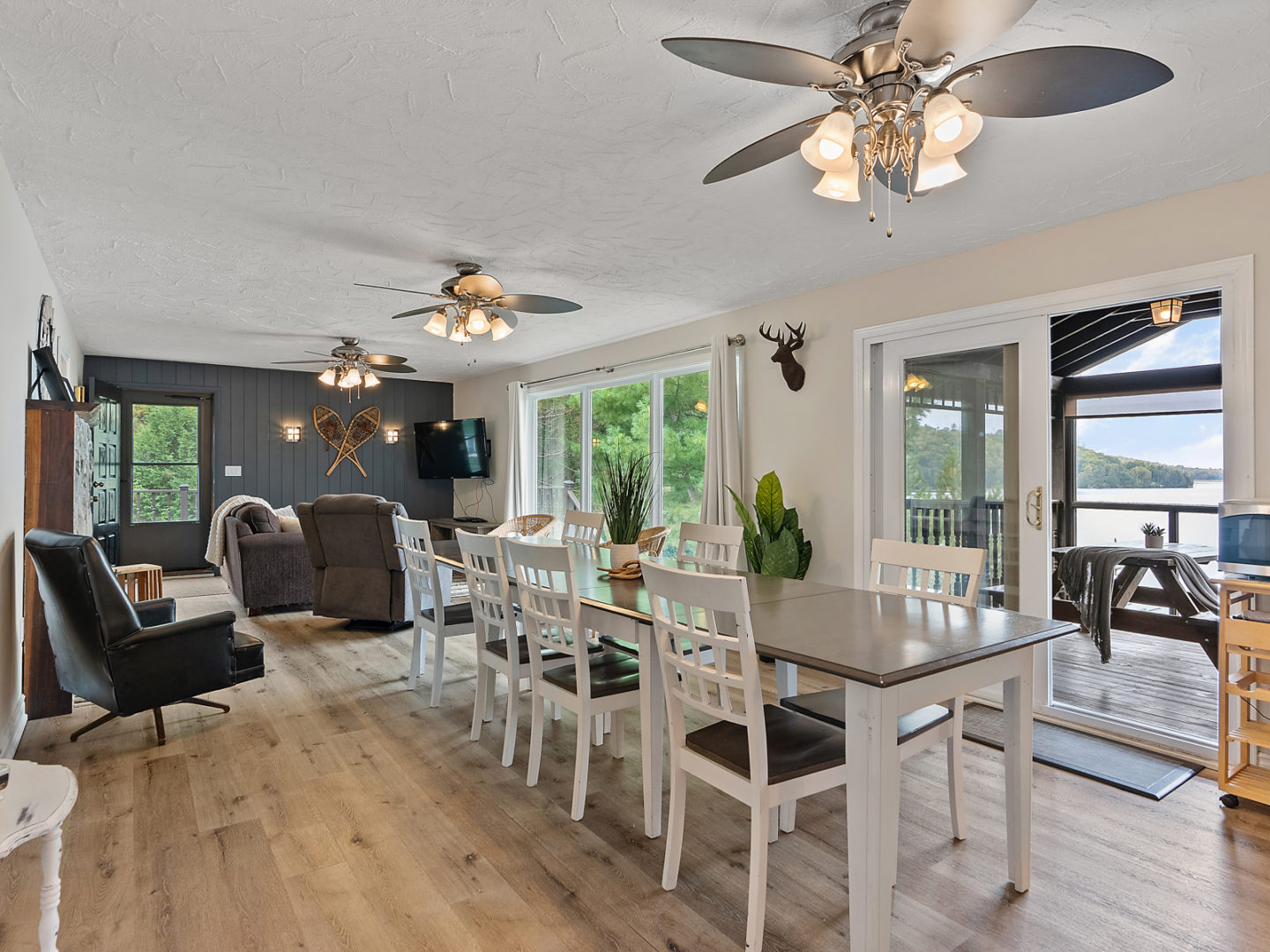An open-concept dining area with a table and chairs, flowing into a living room.