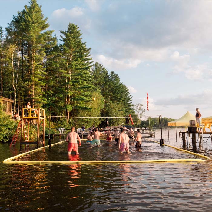 Men playing volleyball in the lake