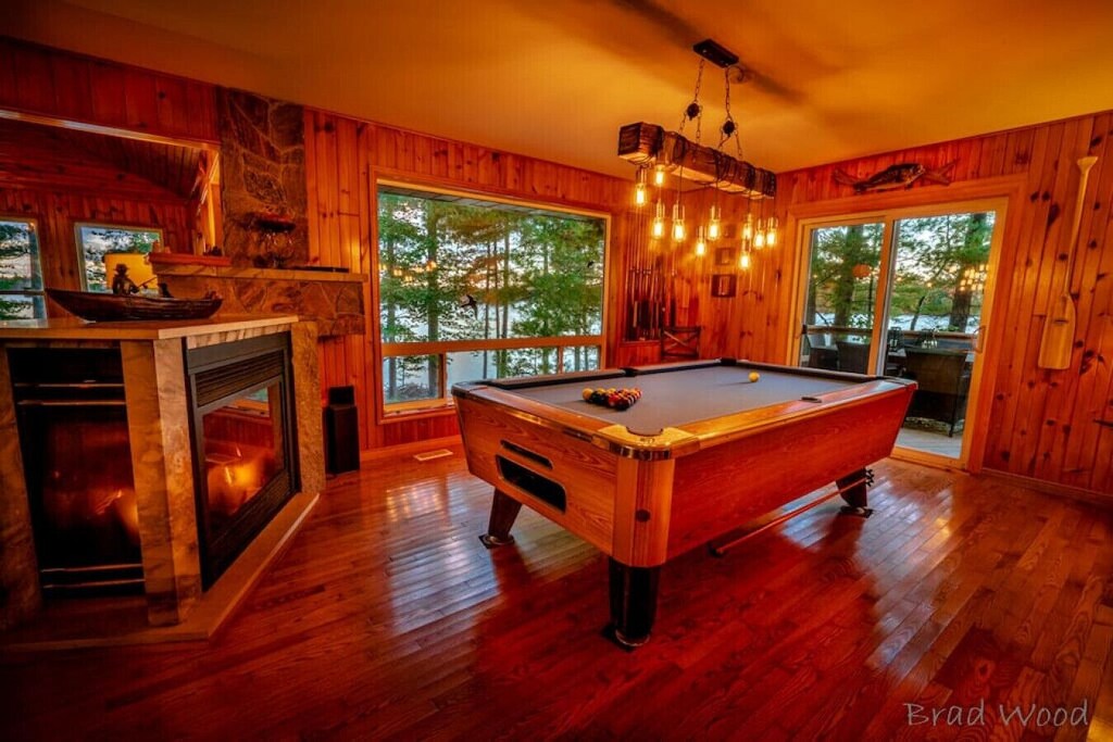 pool table beside a fireplace
