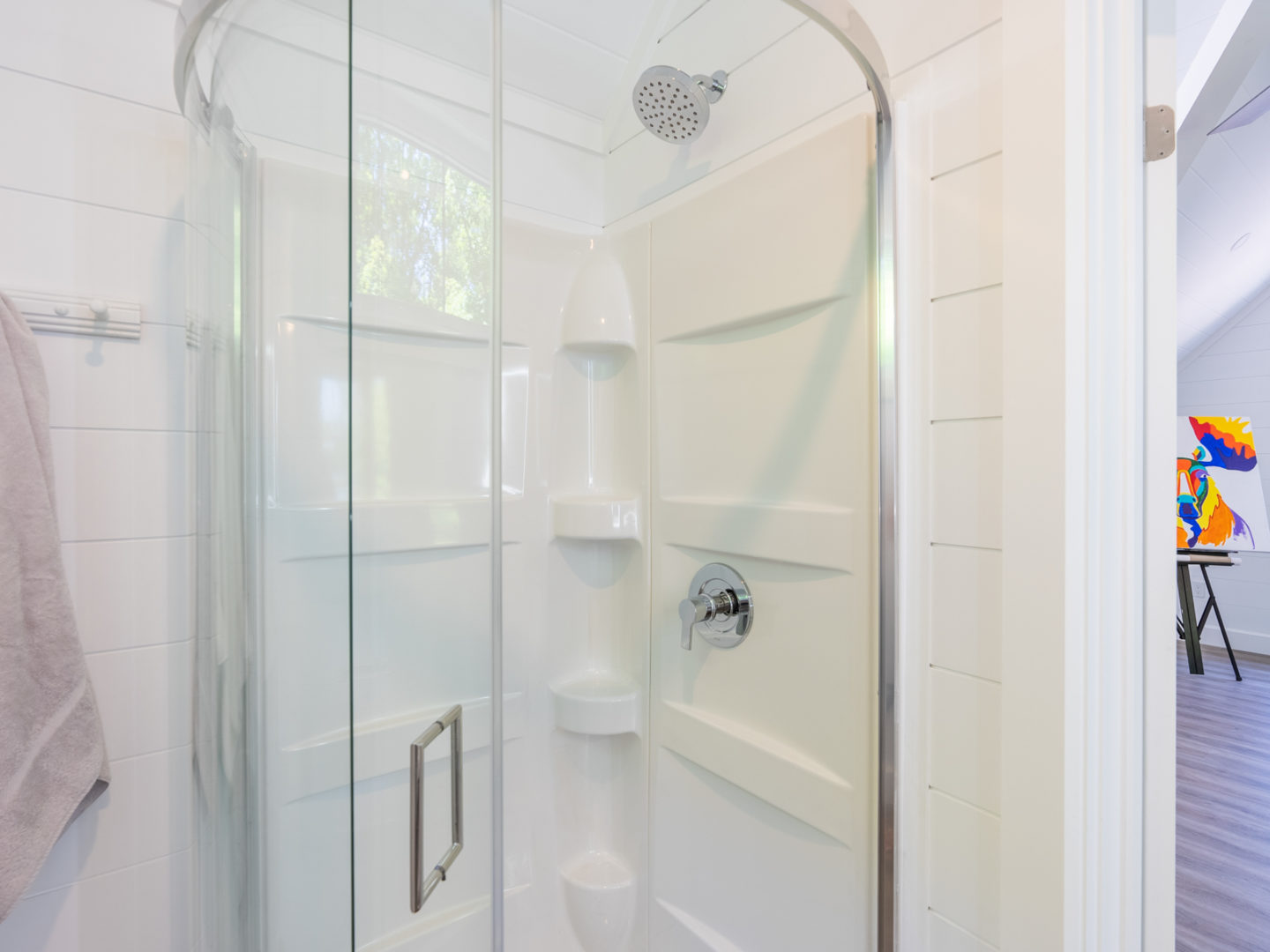 A walk-in shower with a glass door.