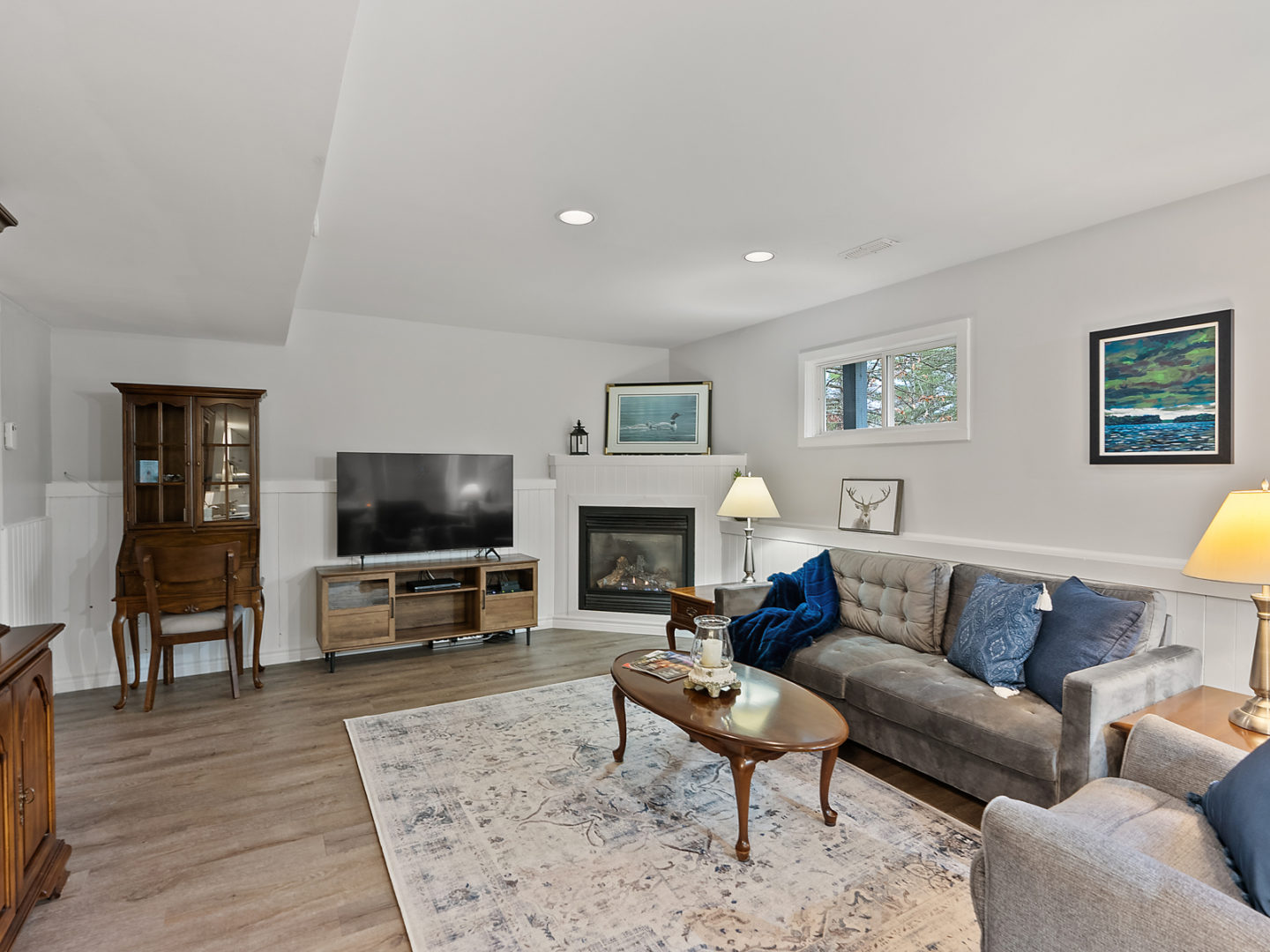 A spacious living room with a couch and a television.