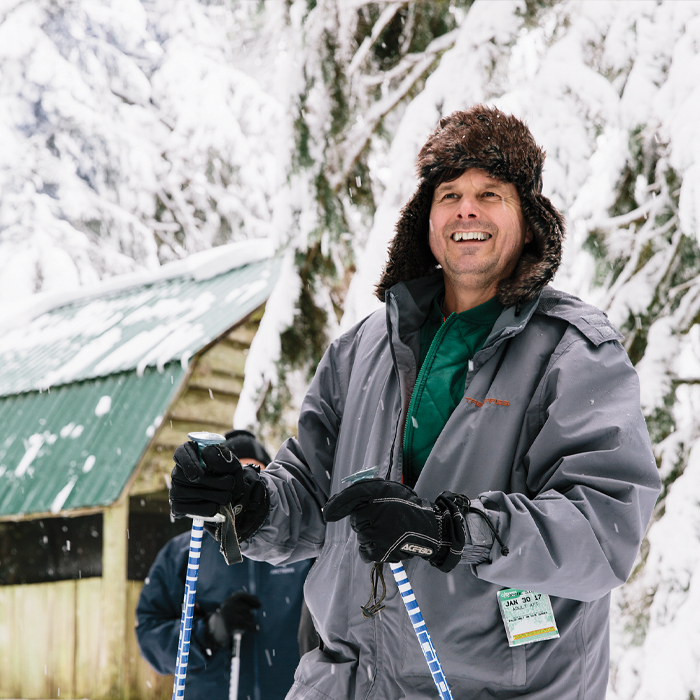 A closeup of Pete holding his ski gear