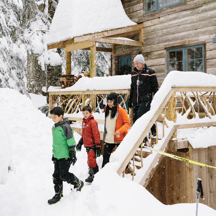 A family walking down the steps of their cabin
