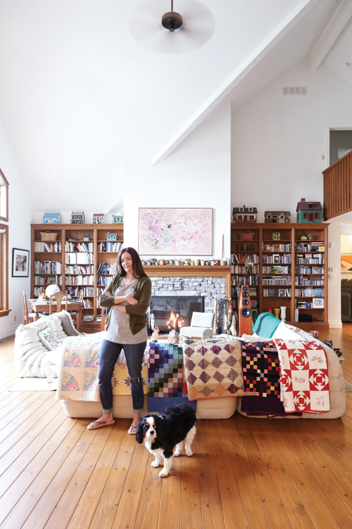 Dyan stands in her cottage living room