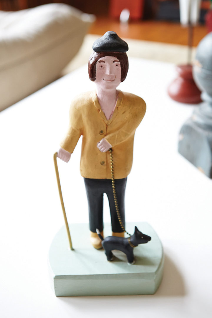 carving of person walking a dog