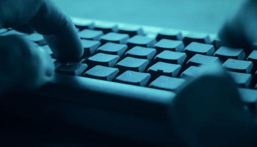 POV hacker cyberattack typing on a keyboard