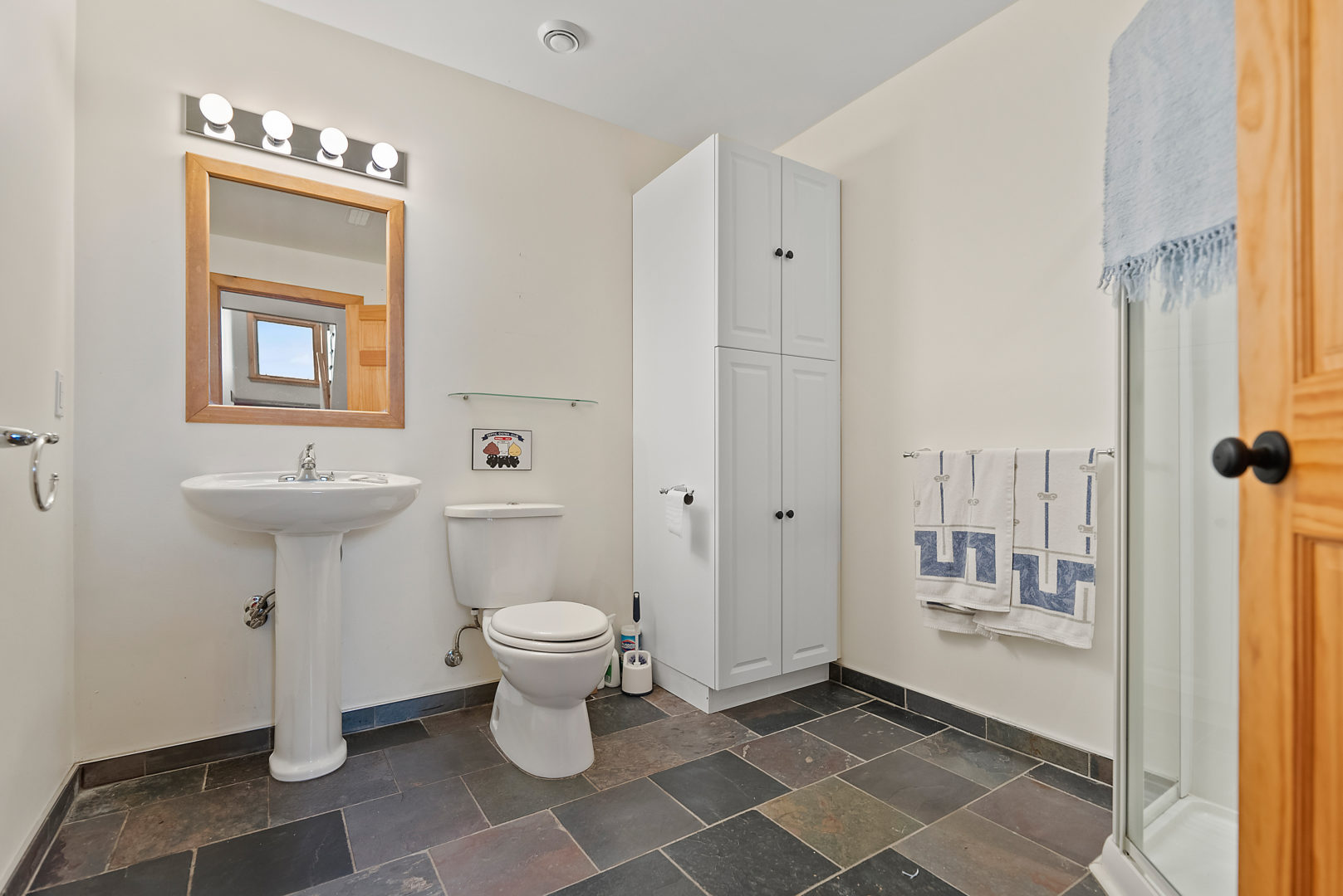A small powder room bathroom with a toilet and a sink.