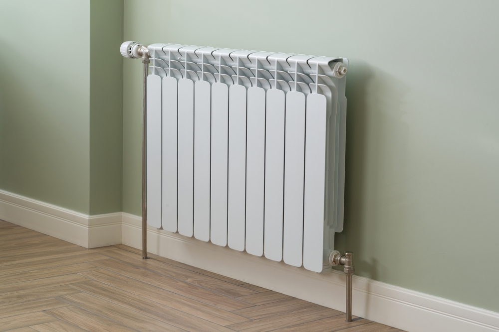 A radiator against a pale green wall